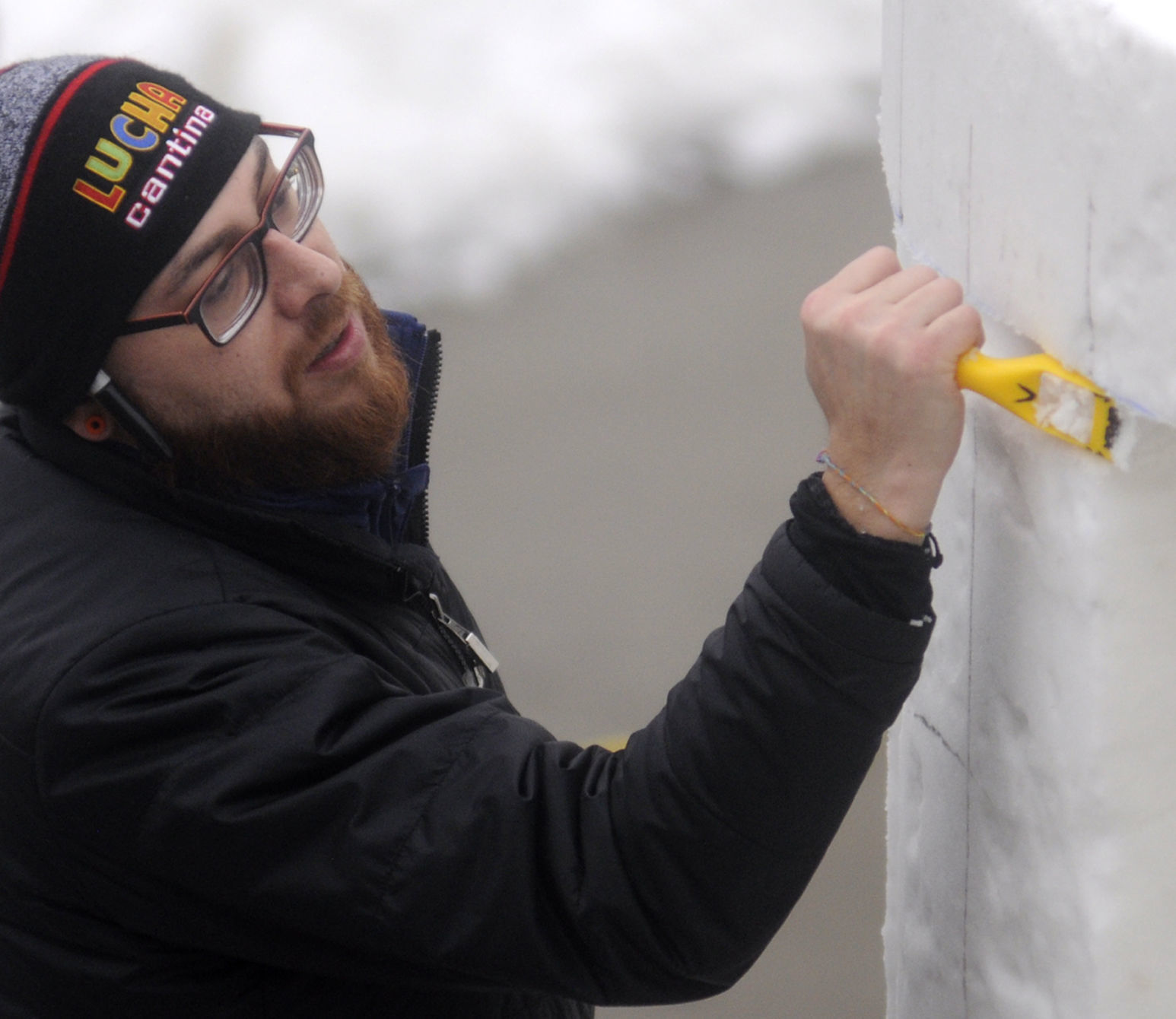 Snow sculptor adding detail